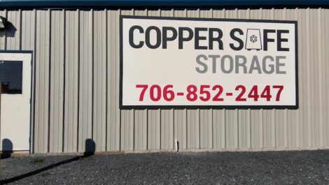 Copper Safe Storage sign on a facility building.