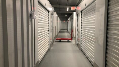 Hallway of indoor storage units and dolly at Stoner Creek Storage in Hermitage.