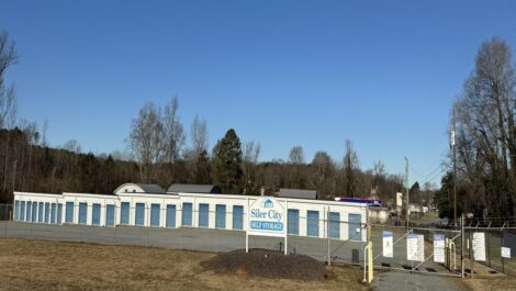 Silver City outdoor storage units with a security fence around the units.