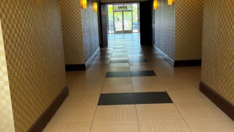 Hallway view with gold walls and tiled flooring.