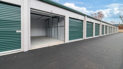 Outdoor storage unit with one door open to show inside.