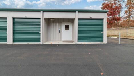 Outdoor storage unit with green doors.