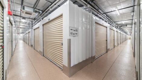 View of indoor storage units from the corner of the hallway showing two hallways of storage units.