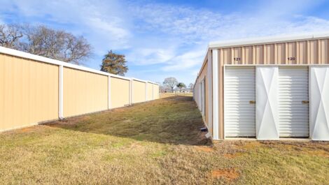 Side view of storage facility with grass.