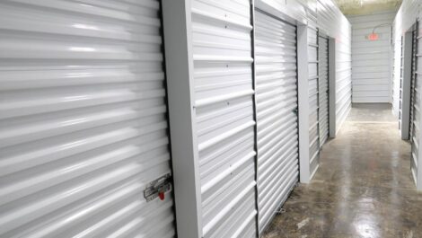 A hallway of indoor storage units.