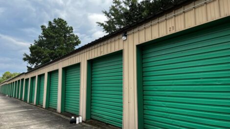 Exterior storage units with green door at Squadron Storage facility.